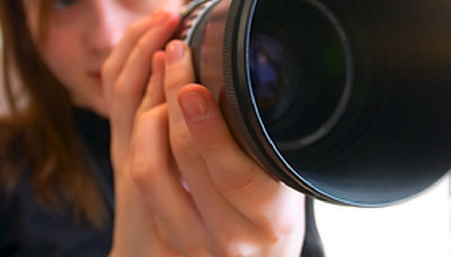 Photo Credit: lens image by Vasiliy Koval from <a href='http://www.fotolia.com'>Fotolia.com</a> A good lens is one of the portrait photographer's most important tools.