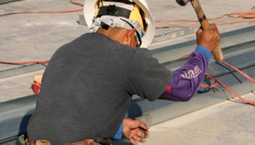 Photo Credit: constrution worker,steel image by Greg Pickens from <a href='http://www.fotolia.com'>Fotolia.com</a> It is the staffing agency's responsibility to provide safety equipment and tools.