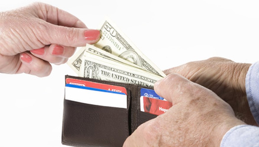 Photo Credit: spending money image by Richard J Thompson from <a href='http://www.fotolia.com'>Fotolia.com</a> Overspending is a mistake.