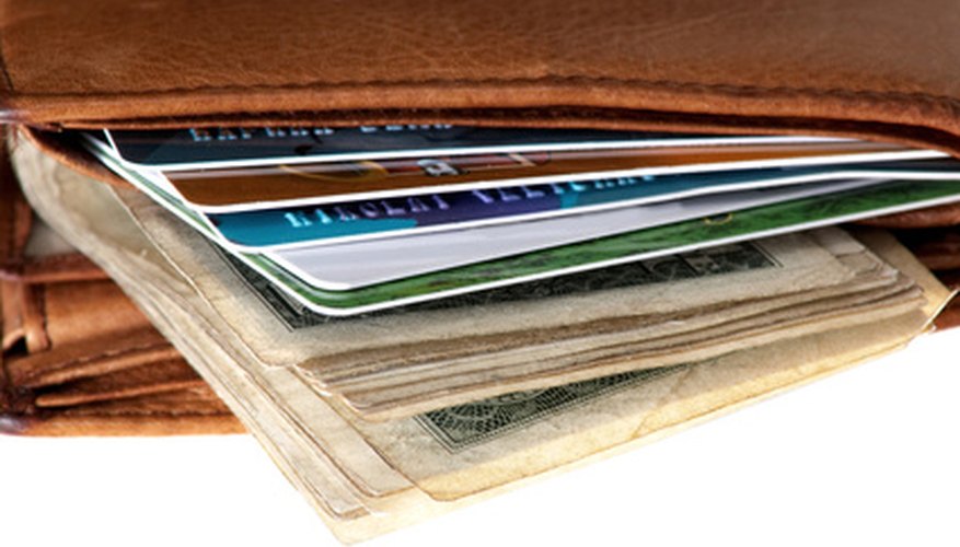 Photo Credit: Credit card in purse image by Mykola Velychko from <a href='http://www.fotolia.com'>Fotolia.com</a>