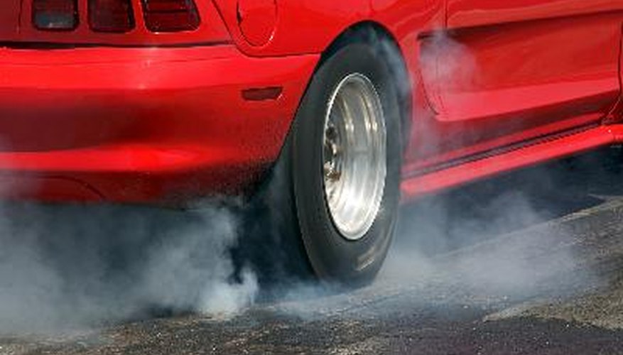 Smoke from the tires of a red racer