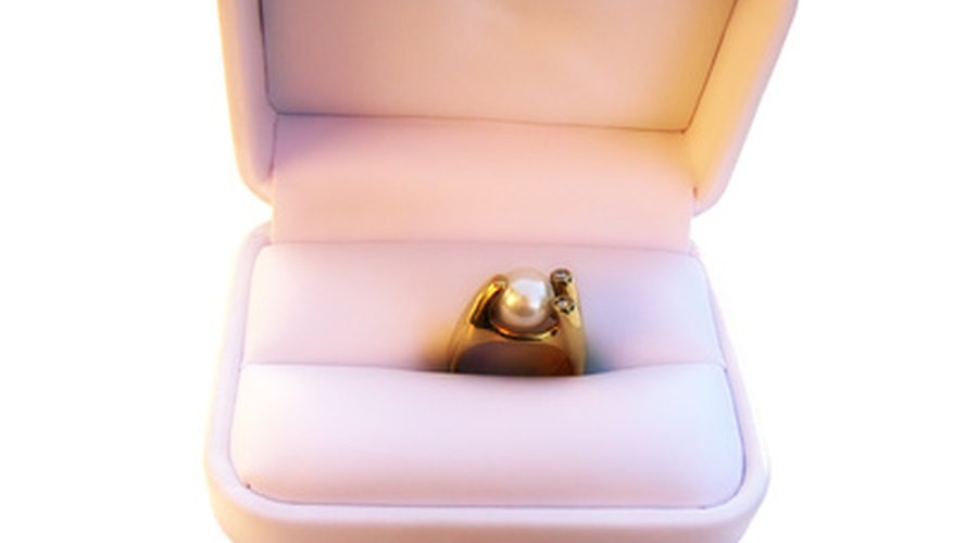 Photo Credit: gold ring with pearl and diamonds image by pr2is from <a href='http://www.fotolia.com'>Fotolia.com</a> Most rings are made with 14kt or 18kt gold.