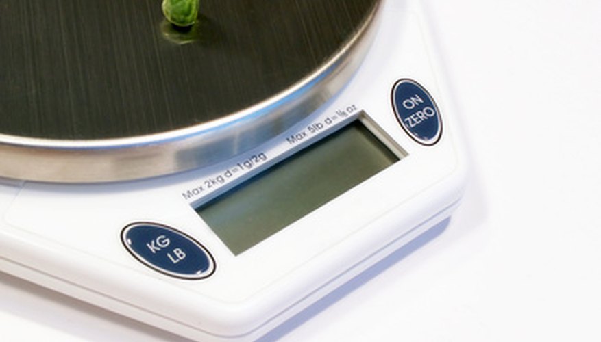 Photo Credit: diet scale image by sparkia from <a href='http://www.fotolia.com'>Fotolia.com</a> Electronic Scale Vs. Beam Scale