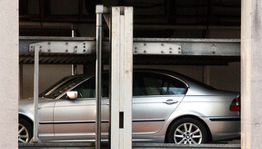 Photo Credit: mechanizied car park showing hydraulic cylinder image by Heng kong Chen from <a href='http://www.fotolia.com'>Fotolia.com</a> Hydraulic machines enable operators to do significant work like lifting heavy cars using little effort.