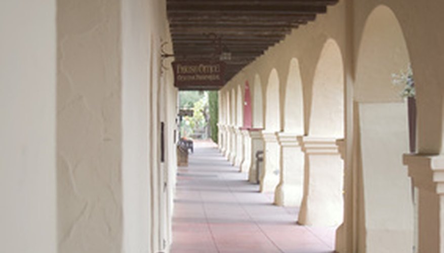 Photo Credit: old mission image by Richard J Thompson from <a href='http://www.fotolia.com'>Fotolia.com</a> Many California missions, including San Fernando Rey, feature colonnades like this one.
