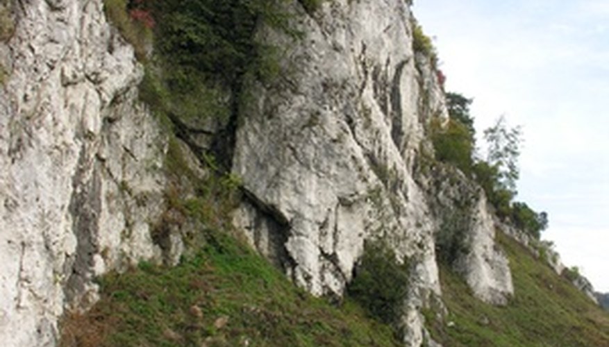 Photo Credit: limestone rocks image by Maria Brzostowska from <a href='http://www.fotolia.com'>Fotolia.com</a> Limestone formations can form caves.