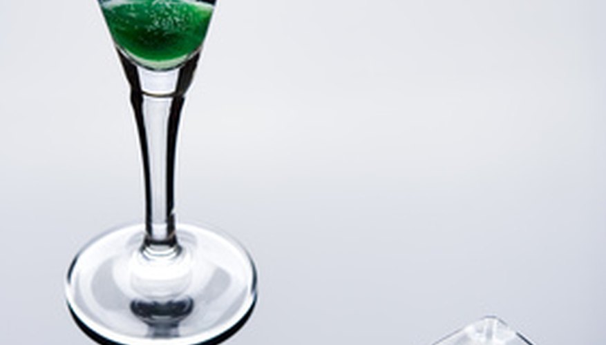Photo Credit: vodka with green cherry and ice cubes image by Monika Olszewska from <a href='http://www.fotolia.com'>Fotolia.com</a> Ad for alcohol using ice cubes, green cherries, glass shapes and reflections to associate the product with sex organs.