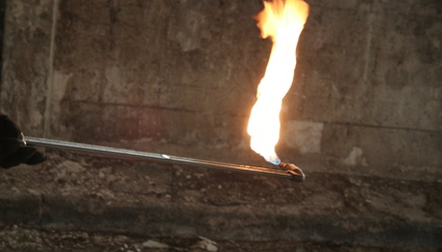 Photo Credit: welding fire image by Kaarel from <a href='http://www.fotolia.com'>Fotolia.com</a> Oxy acetylene welding uses a gas-fed torch to generate heat for the weld.