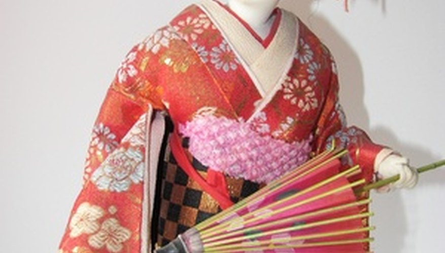 Traditional geisha doll in full costume. Traditional geisha doll in full costume.