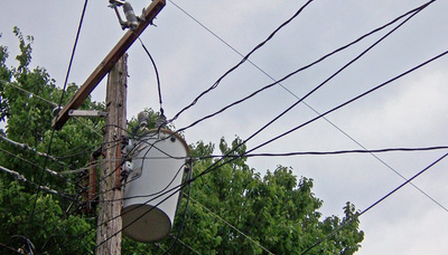 Photo Credit: transformer image by palms from <a href='http://www.fotolia.com'>Fotolia.com</a> Electricity made high-voltage to reduce losses over long distances is transformed to low voltage for residential use.
