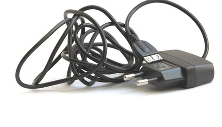 Photo Credit: ac/dc image by Maxim Kulemza from <a href='http://www.fotolia.com'>Fotolia.com</a> An AC adapter converts AC to DC for electronic circuit devices.