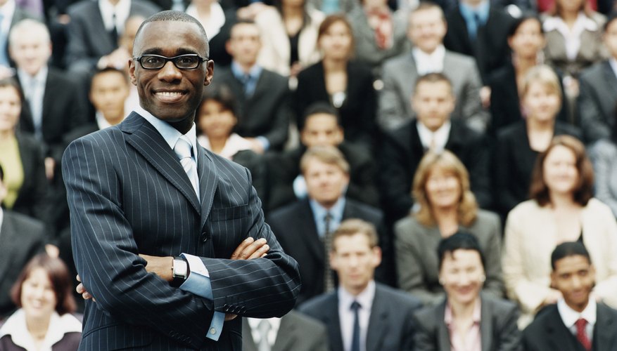 Male CEO Standing in Front of a Large Group of Business People