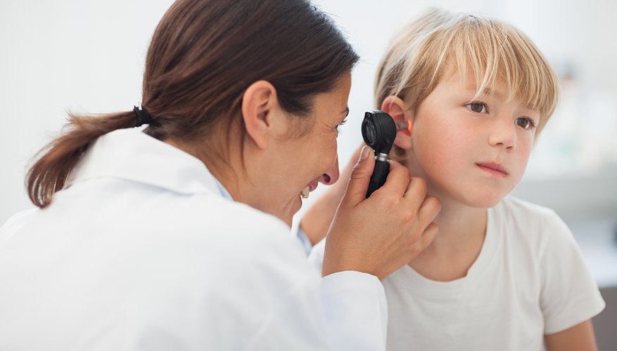 Photo Credit: Wavebreakmedia Ltd/Wavebreak Media/Getty Images Doctor looking in patients ear