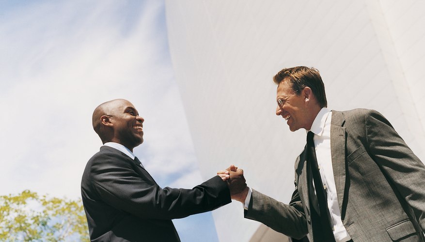 Businessmen Smiling and Shaking Hands