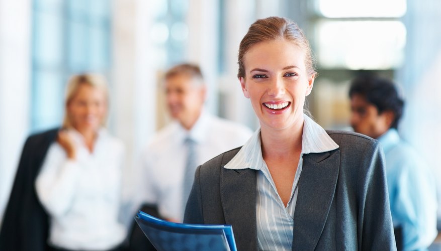 Photo Credit: Jacob Wackerhausen/iStock/Getty Images woman smiling at work