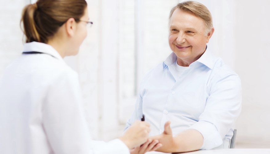 Senior patient talking to doctor in office.