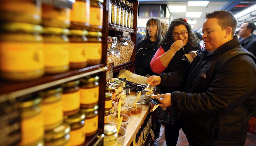 Photo Credit: Spencer Platt/Getty Images News/Getty Images People sample olive oils inside market in Brooklyn, NY.