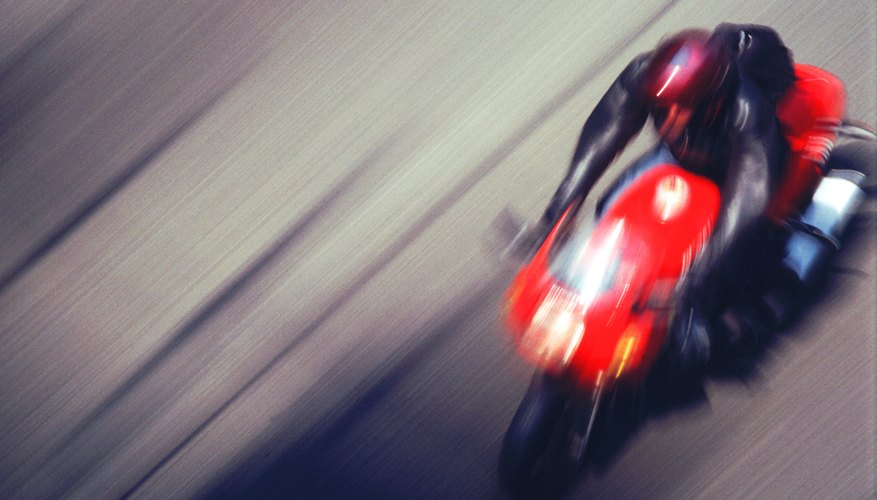 Man riding motorbike on street (blurred motion)