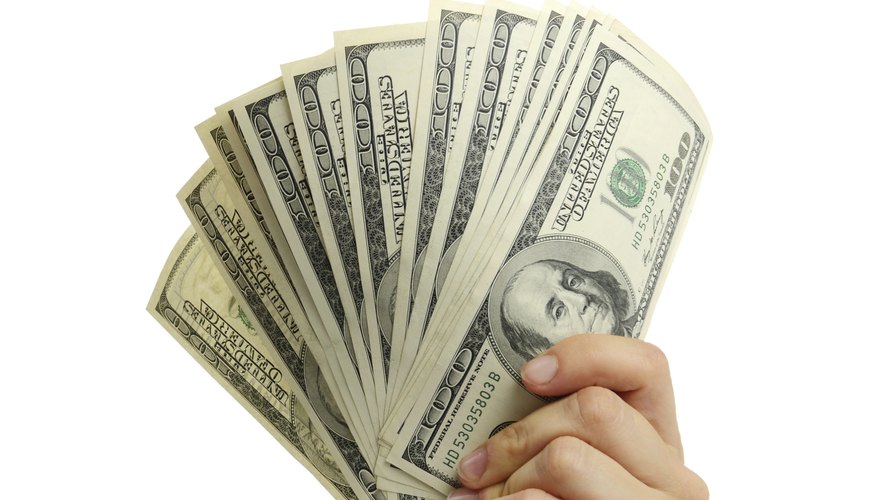 woman hand with 100 dollar bills