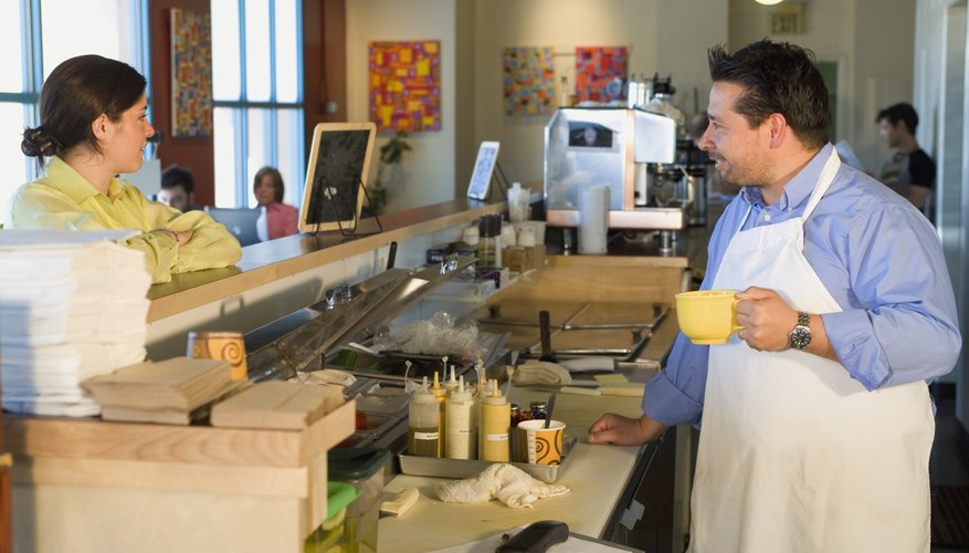 Hispanic cafe owner helping customer