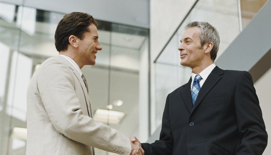 Two Mature Businessmen Shake Hands