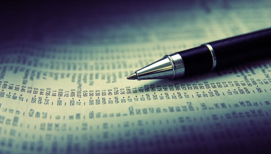 Close up of a pen sitting on the stock indices page of the newspaper