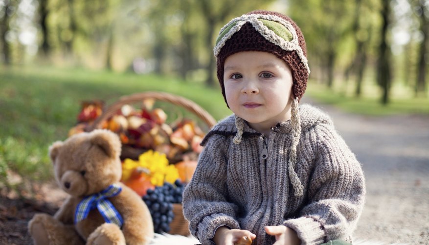 A portrait of a little boy at a teddy bear picnic in the park. A portrait of a little boy at a teddy bear picnic in the park.