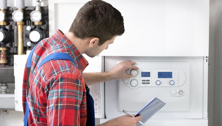 Technician servicing heating boiler