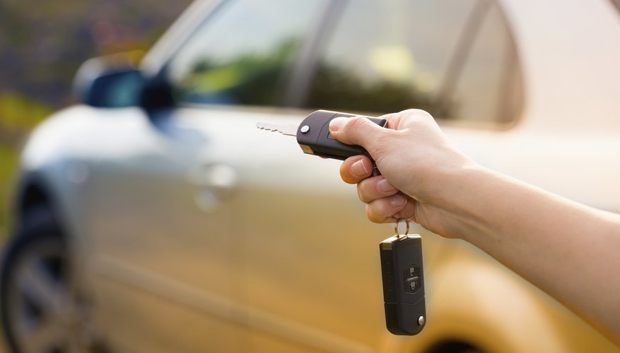 A close-up of a woman setting a car alarm with her key chain.