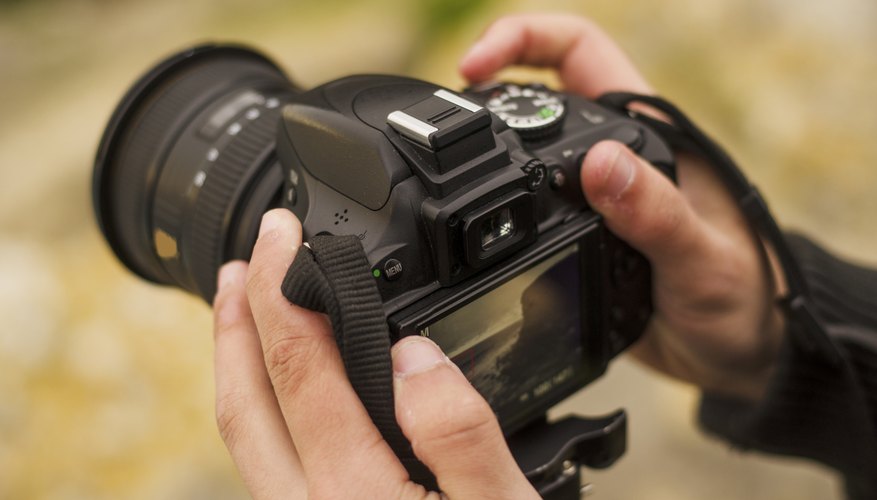 Photo Credit: MarioGuti/iStock/Getty Images Setting up a digital camera on a tripod