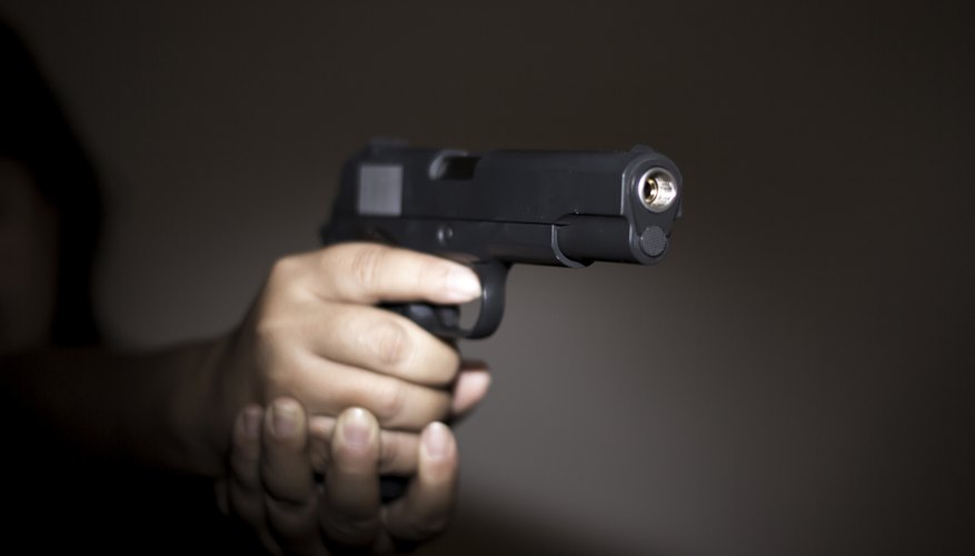 A handgun is being help up.
