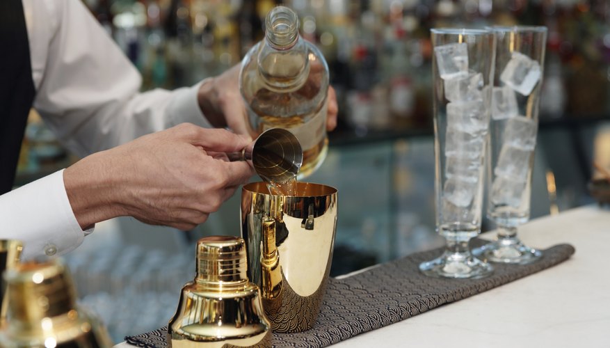 Photo Credit: Kondor83/iStock/Getty Images A bartender pouring drinks.