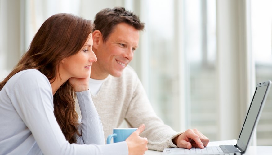 Photo Credit: Jacob Wackerhausen/iStock/Getty Images couple researching on computer