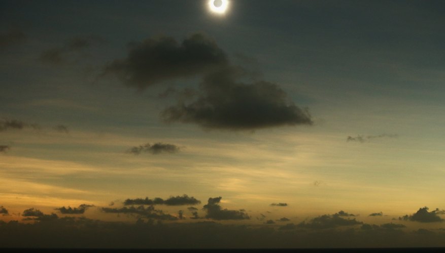Photo Credit: Mark Kolbe/Getty Images News/Getty Images A clear view of a solar eclipse occurring above the clouds.