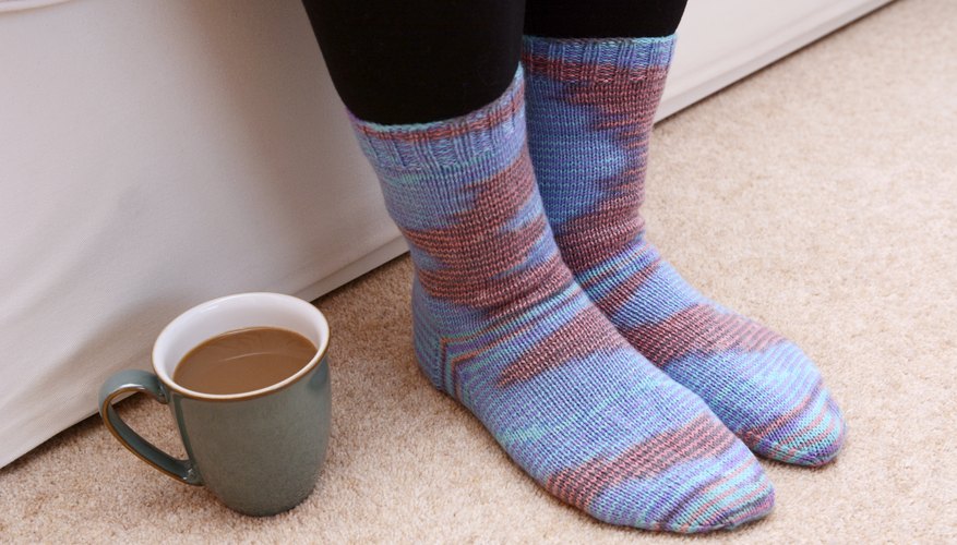 A women's knitted socks on a carpet. A women's knitted socks on a carpet.