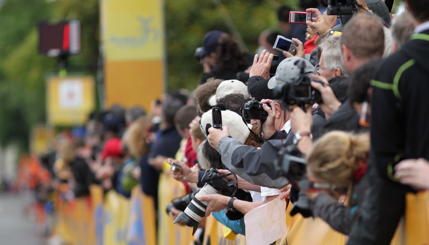 Photo Credit: Doug Pensinger/Getty Images Sport/Getty Images Fans with cameras at bicycling event