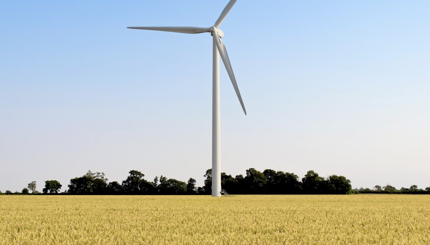 Photo Credit: binkski/iStock/Getty Images A wind turbine spins in the middle of a wheat field.