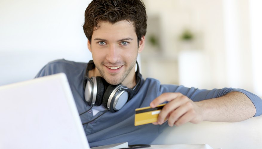 Image of a man holding a debit card.