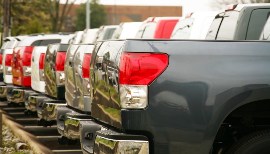 A fleet of parked pick up trucks.