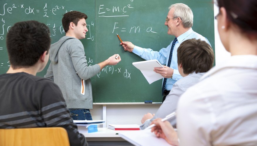 Photo Credit: Alexander Raths/iStock/Getty Images College student working out math problem on chalkboard.