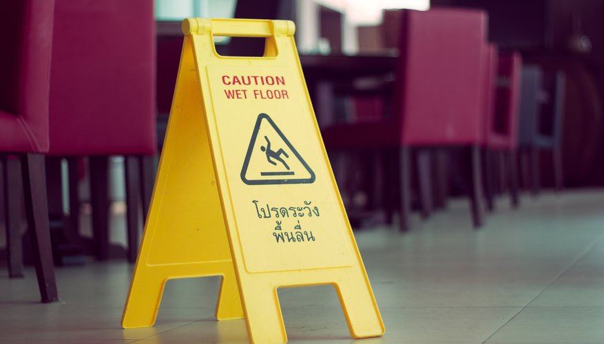 Photo Credit: graphicdna/iStock/Getty Images wet floor sign in dining room