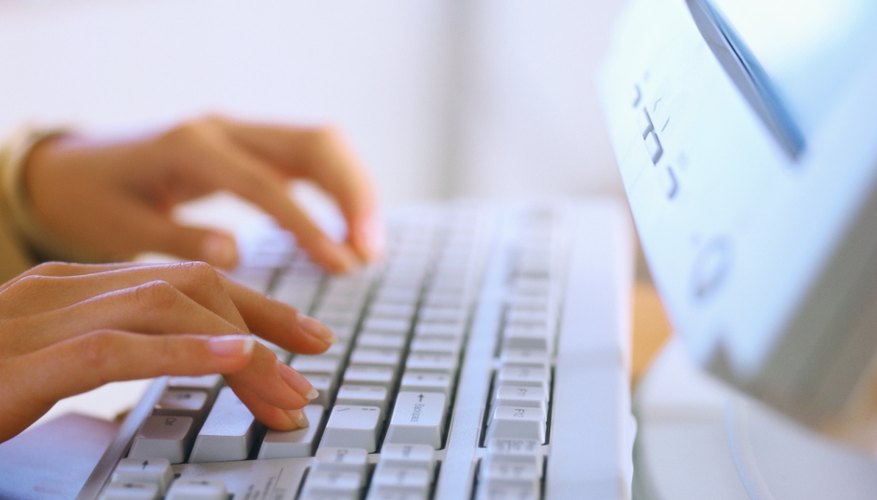 close-up of hands using a keyboard