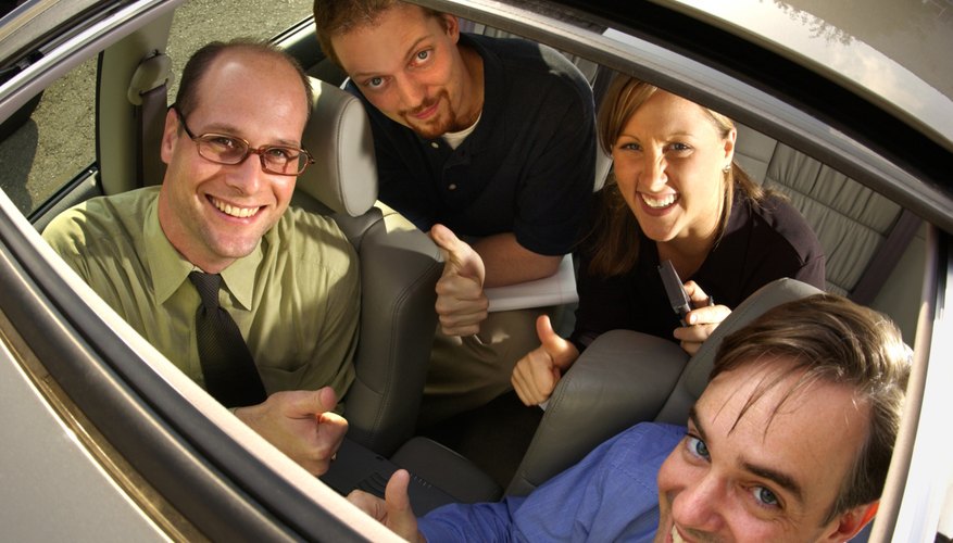 Smiling businesspeople inside car