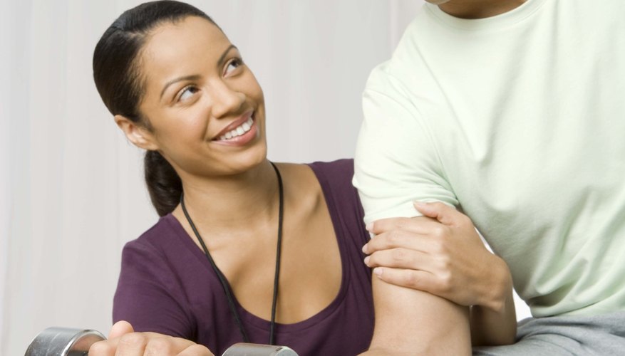 Photo Credit: Jupiterimages/Creatas/Getty Images Sports therapist assisting patient
