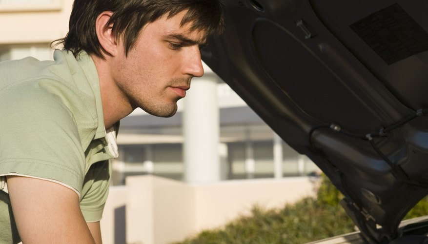 Man looking at car engine