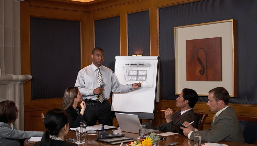 Man giving presentation to colleagues in conference room