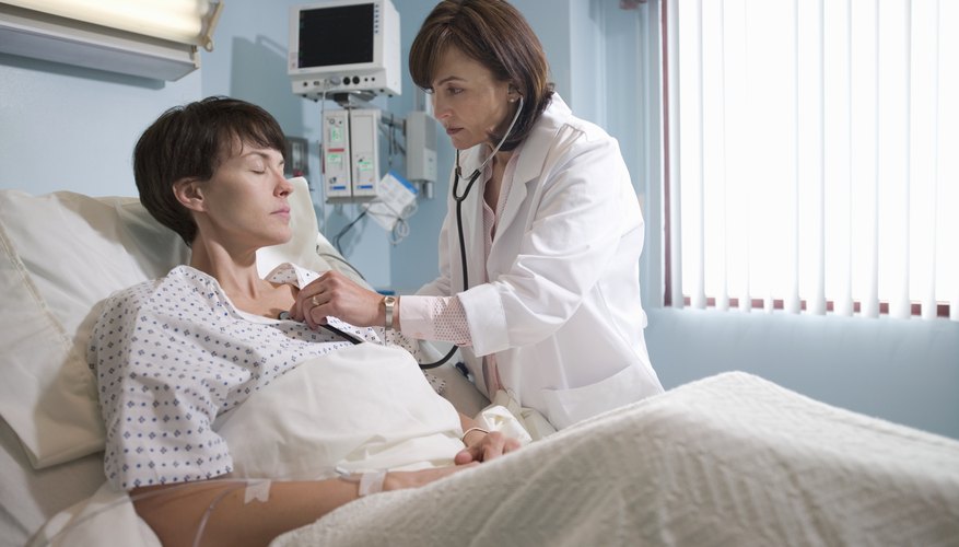 Doctor examining hospital patient Doctor examining hospital patient