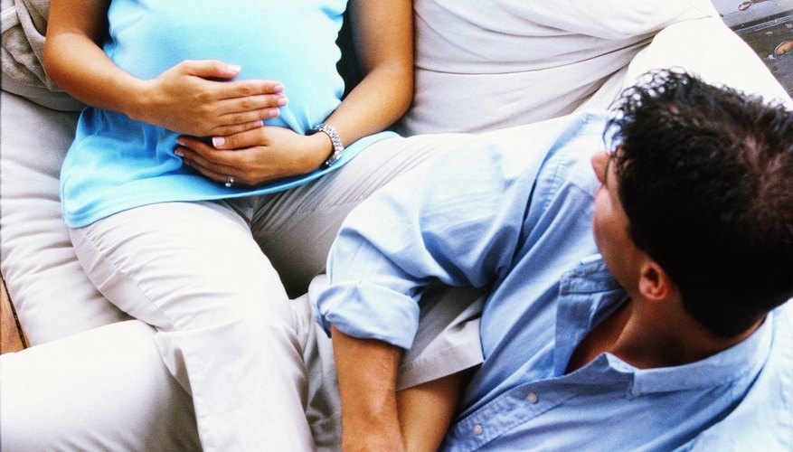 Pregnant woman and husband rubbing feet Pregnant woman and husband rubbing feet