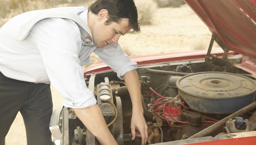 Man fixing vintage convertible