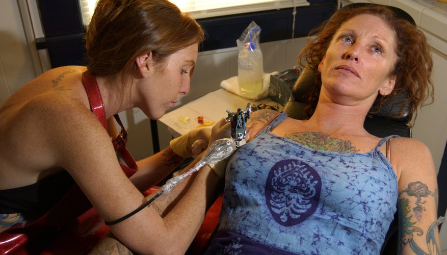 Woman getting tattoo